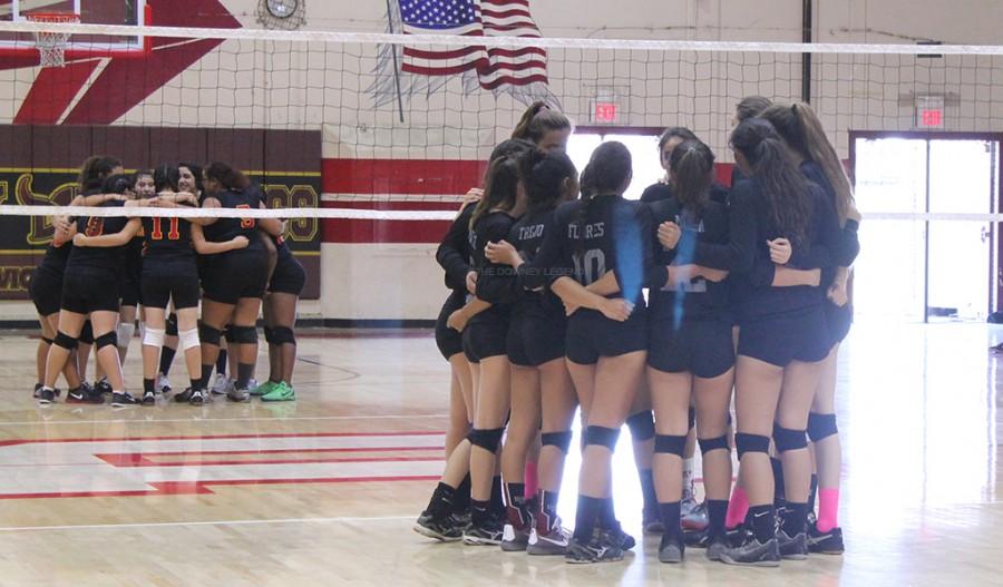 The girls varsity volleyball team does a quick huddle before their game vs. Dominguez in the DHS gym on Tuesday, Oct.19. “I feel like we did very good as a whole team by holding them at only a couple of points,” Destiny Gomez, 11, said. “We didn’t let them bring us down.”